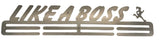 A stainless steel text piece saying 'LIKE A BOSS' mounted on a wall.